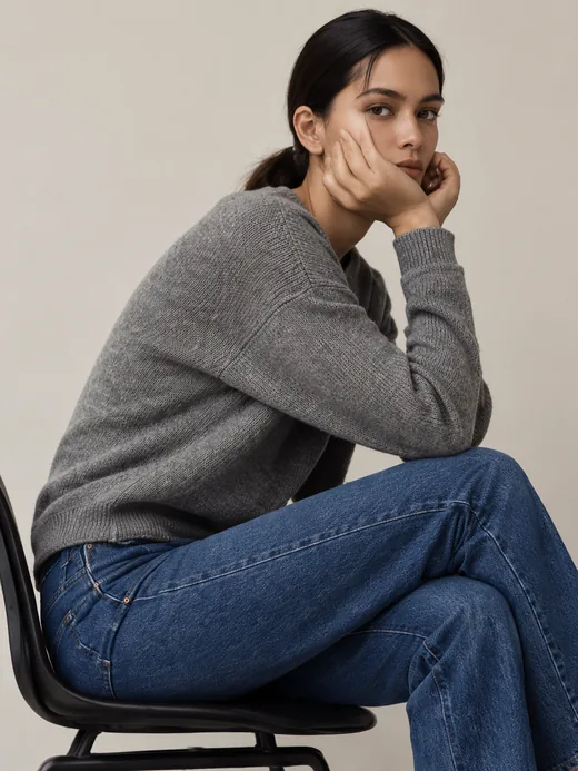 A grey cashmere sweater with straight-leg denim